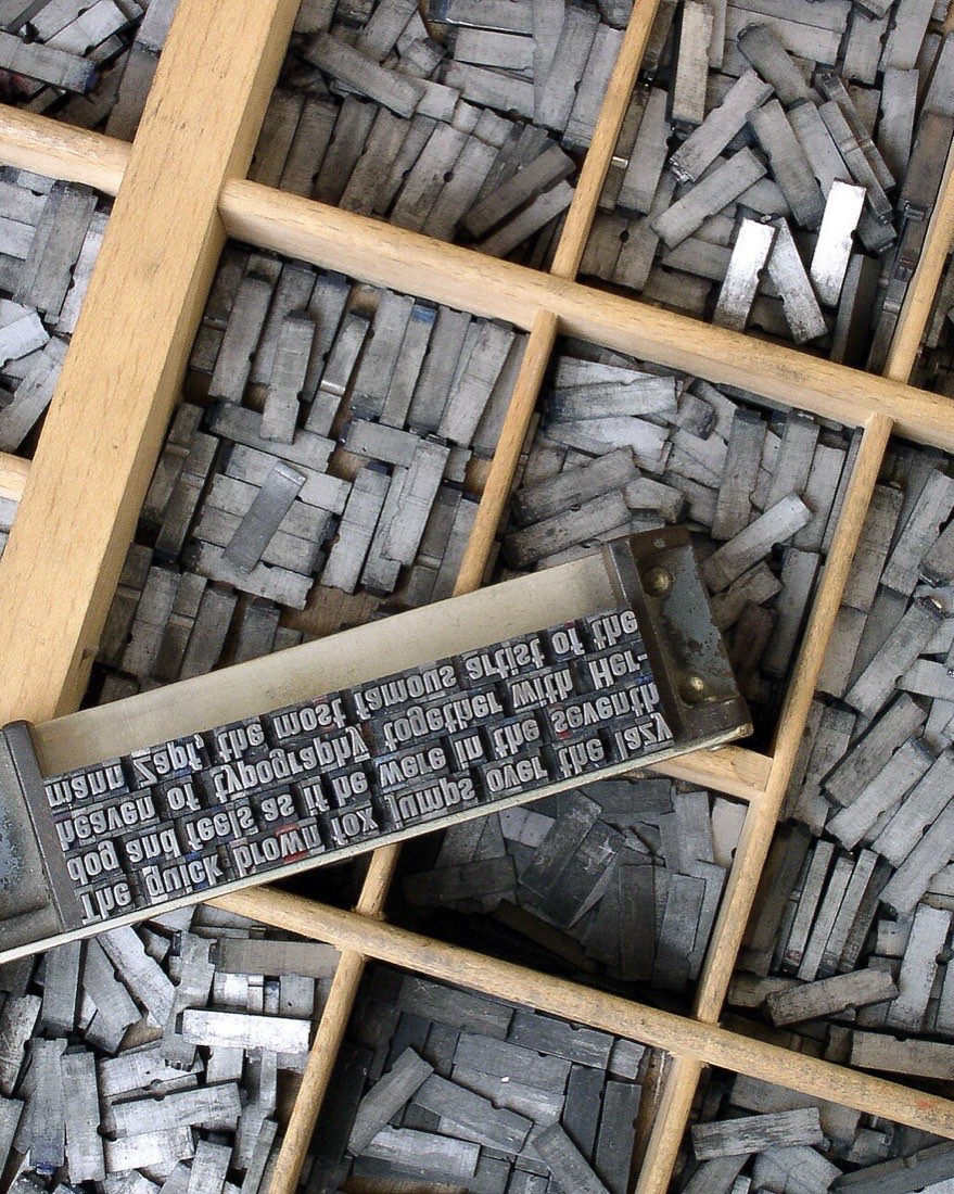 Metal type sorted into the compartments of a wooden type case